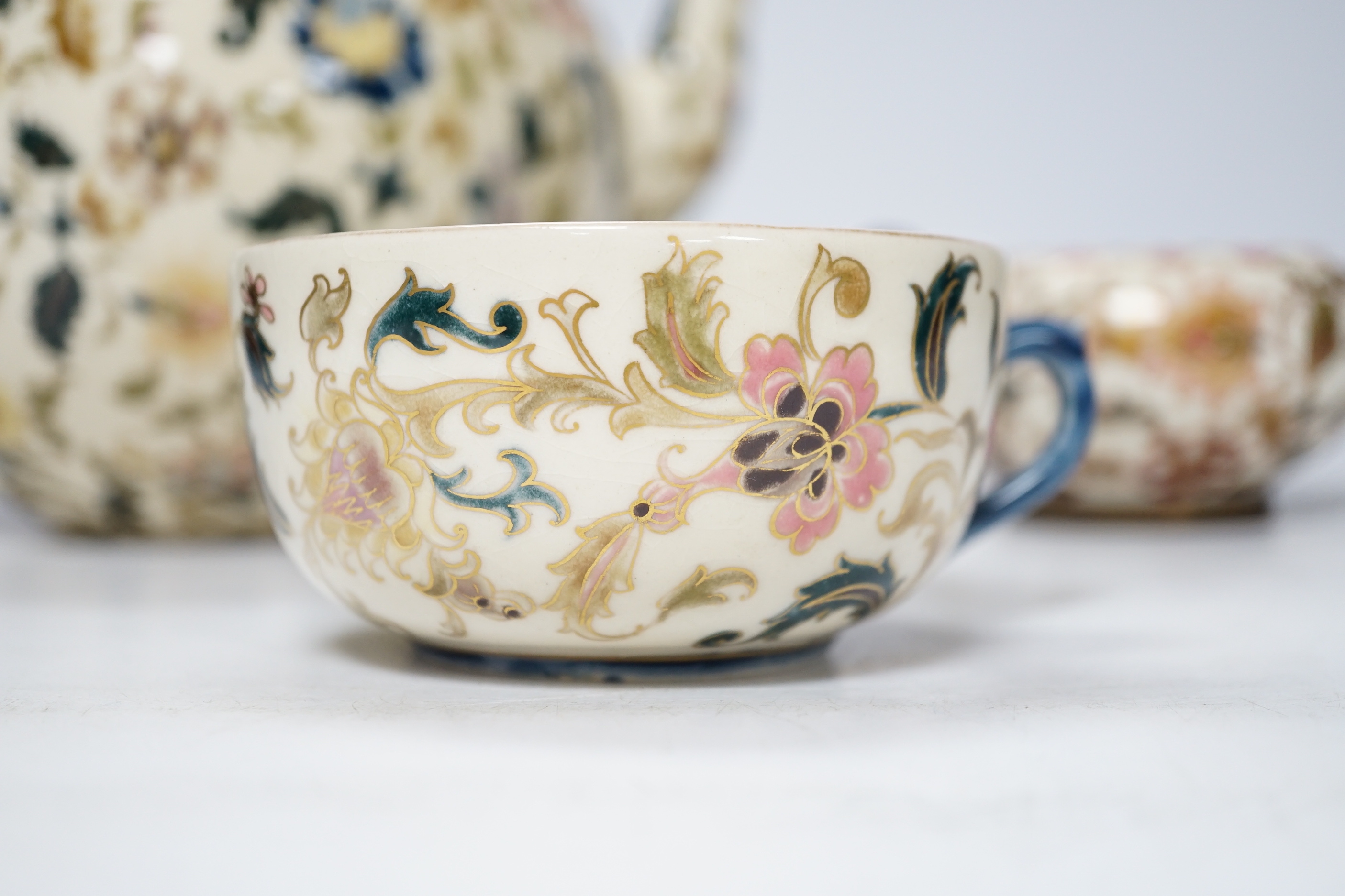 A Zsolnay teapot, teacup and sugar bowl, tallest 22cm